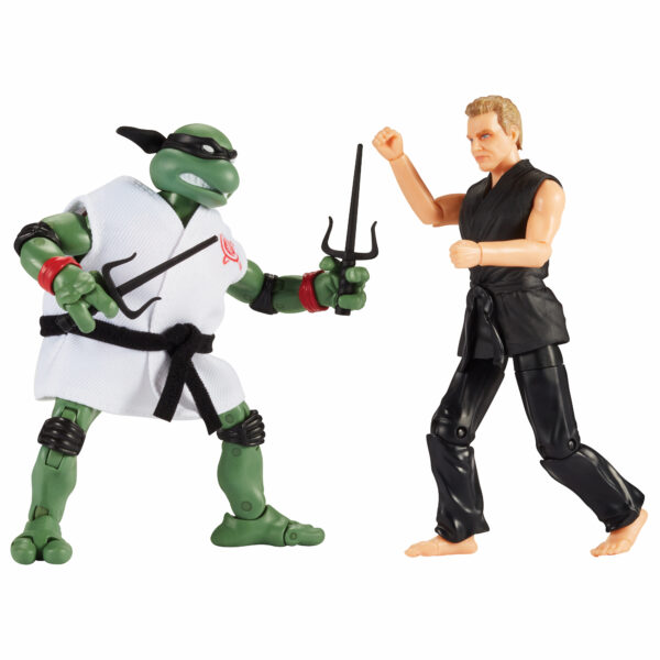STL214429_1 TMNT X COBRA KAI RAPHAEL VS JOHN KREESE AF 2PK